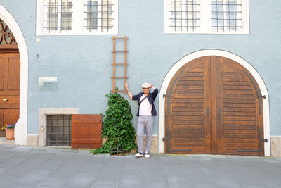 Full length of man standing outside building