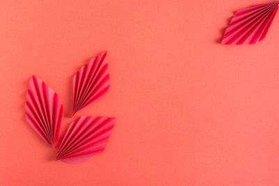 Monochrome red background with origami leaves. eco friendly decor