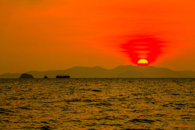 Scenic view of sea against orange sky