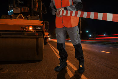 Low section of man walking on street