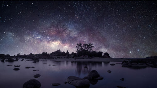 Scenic view of lake against sky at night