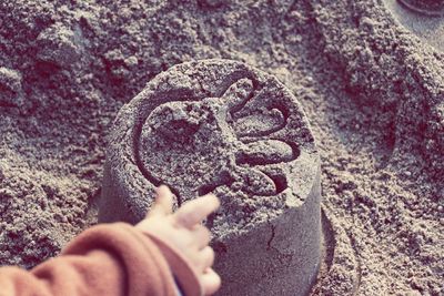 Child's hand on sand