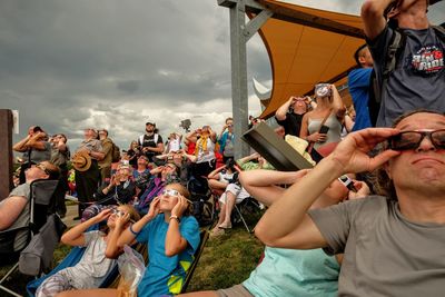 People enjoying music concert against sky