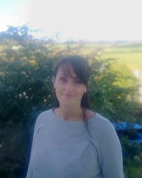 Portrait of a smiling young woman standing outdoors