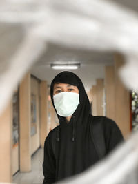 Portrait of a serious young woman wearing mask