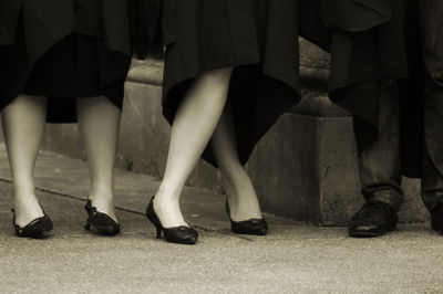 Low section of man and women standing outdoors