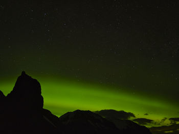 Low angle view of silhouette mountain against sky at night