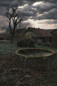 Abandoned house on field against sky