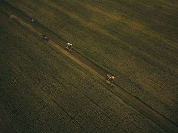 Aerial view of machinery working in agricultural field