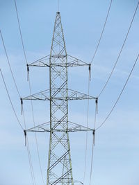 Low angle view of electricity pylon against sky