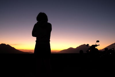 Silhouette of people standing on landscape