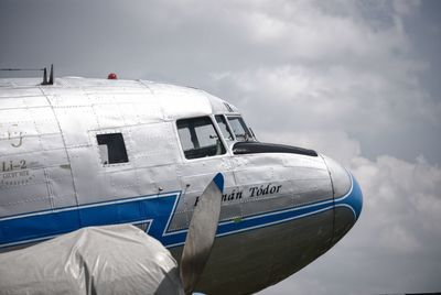 View of airplane against cloudy sky