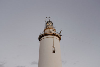 Low angle view of lighthouse against building