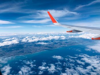 Aircraft wing in sky