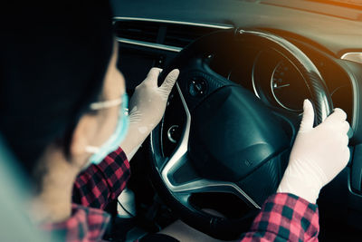 Midsection of man sitting in car