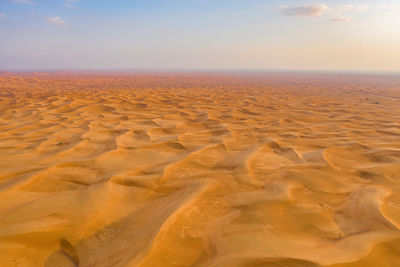 Scenic view of desert against sky during sunset