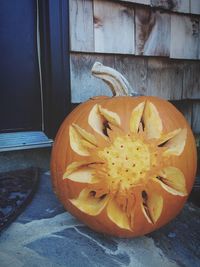 Close-up of pumpkin against orange wall