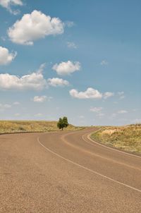 Empty road along countryside landscape