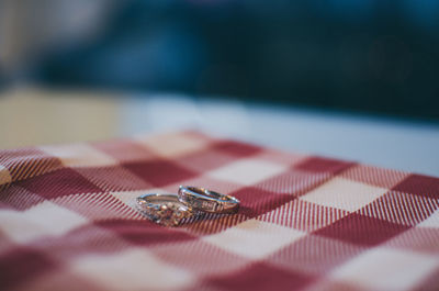 Close-up of wedding rings on table