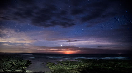 Scenic view of sea against sky at night