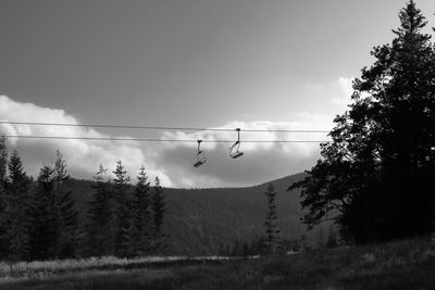 Low angle view of ski lift against sky