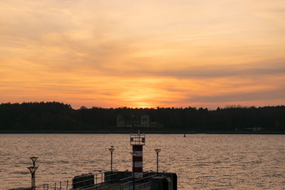 Scenic view of lake against orange sky