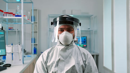Portrait of scientist wearing face mask at laboratory