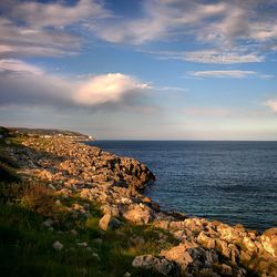 Scenic view of sea against cloudy sky