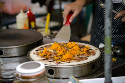 Close-up of man preparing food in temple