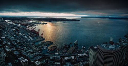 High angle view of cityscape by sea against sky