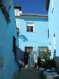 Clothes drying on alley amidst buildings in town