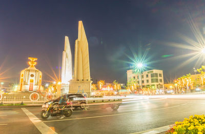 Cars on illuminated street at night