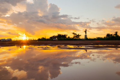 Scenic view of lake against sky during sunset