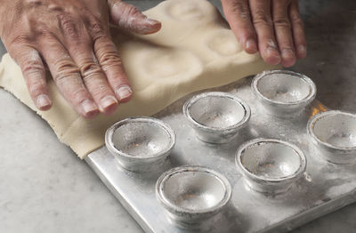 Cropped hands of chef preparing food on table in commercial kitchen