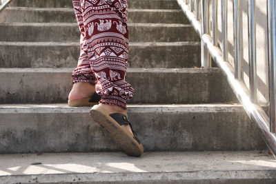 Low section of woman walking on staircase