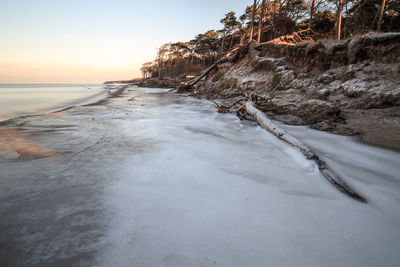 High angle view of beach and sea against sky during sunset