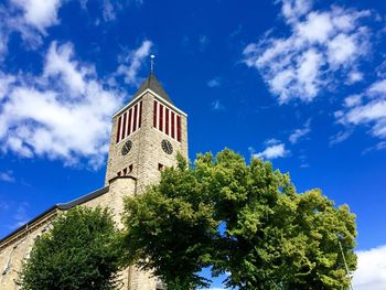 Low angle view of clock tower against sky