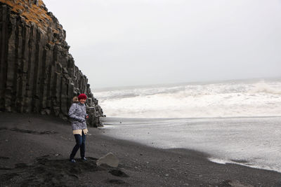 Full length of person on beach against sky