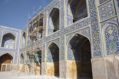 Low angle view of historical building with beautiful murals on tiles
