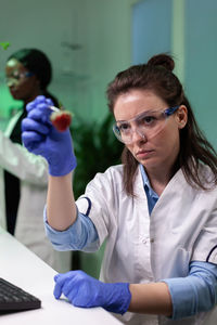 Scientist holding test tube at lab