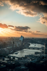 High angle view of buildings against cloudy sky during sunset