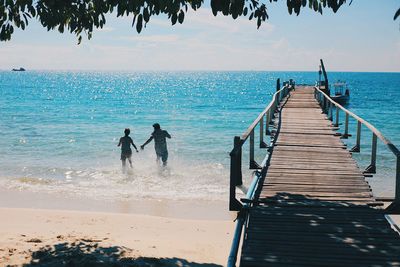 People on beach against sky