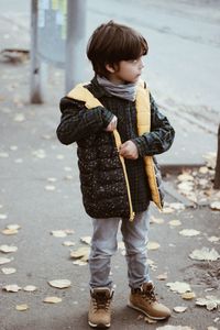 Full length of cute boy standing on street