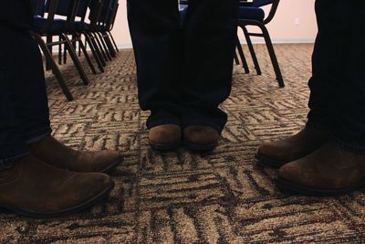 Low section of woman relaxing on tiled floor