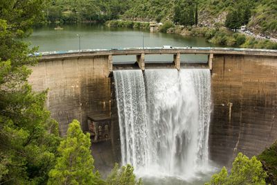 Scenic view of waterfall by trees