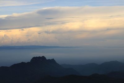 Scenic view of silhouette mountains against sky at sunset