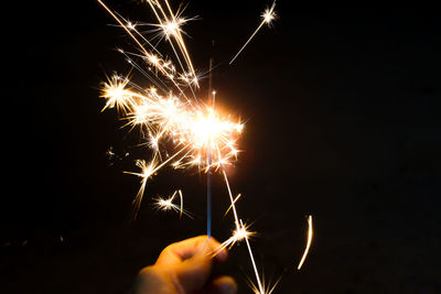 Low angle view of firework display at night