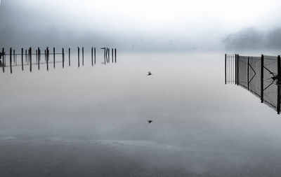 Scenic view of lake against sky during winter