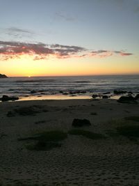 Scenic view of beach against sky during sunset