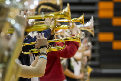 The hands of a trumpet player in a row of brass